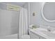 Cozy bathroom with a shower-tub combination, white fixtures, and a round mirror at 308 Fleming Dr, Durham, NC 27712
