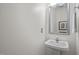 Clean and simple bathroom with a pedestal sink and decorative mirror at 308 Fleming Dr, Durham, NC 27712