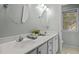 Bathroom with dual sinks, vanity with gold hardware, and a window for natural light at 308 Fleming Dr, Durham, NC 27712