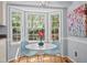 Sunlit breakfast nook features hardwood floors, a cozy table, and a view to the outdoors at 308 Fleming Dr, Durham, NC 27712