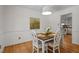 Bright dining room with hardwood floors and stylish decor, adjacent to an open kitchen at 308 Fleming Dr, Durham, NC 27712