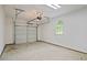 Clean garage with an automatic door, a window for light, and a concrete floor at 308 Fleming Dr, Durham, NC 27712