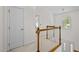 Hallway featuring neutral carpet, wooden railings, and a modern chandelier at 308 Fleming Dr, Durham, NC 27712