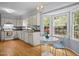 Well-equipped kitchen with a breakfast nook offering a scenic view and hardwood floors at 308 Fleming Dr, Durham, NC 27712