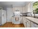 Bright kitchen features white appliances, hardwood flooring, and plenty of counter space at 308 Fleming Dr, Durham, NC 27712