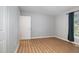Neutral bedroom featuring luxury vinyl plank flooring, closet, and window at 308 Plaza Dr, Garner, NC 27529