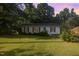 Charming single-story home features a well-maintained lawn and cozy curb appeal surrounded by mature trees at 308 Plaza Dr, Garner, NC 27529