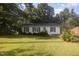 Charming single-story home features a well-maintained lawn and cozy curb appeal surrounded by mature trees at 308 Plaza Dr, Garner, NC 27529