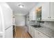 Spacious kitchen featuring white cabinets, granite countertops, and stainless steel appliances at 308 Plaza Dr, Garner, NC 27529