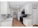 Updated kitchen with stainless appliances, light countertops, and luxury vinyl plank flooring at 308 Plaza Dr, Garner, NC 27529