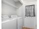 Functional laundry room with modern washer and dryer, plus convenient shelving at 308 Plaza Dr, Garner, NC 27529