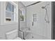 Modern bathroom features a glass-enclosed tiled shower with bench and sleek fixtures at 313 W Murray Ave, Durham, NC 27704