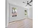 Bright bedroom features hardwood floors, ceiling fan, crown molding, and two windows with natural light at 313 W Murray Ave, Durham, NC 27704