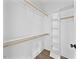 Walk-in closet featuring built-in shelving, a hanging rod, and hardwood flooring at 313 W Murray Ave, Durham, NC 27704