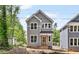 Charming two-story home with gray siding, white trim, and a welcoming front porch in a wooded neighborhood at 313 W Murray Ave, Durham, NC 27704