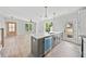 Open kitchen featuring a spacious island with sink, modern appliances, and hardwood floors at 313 W Murray Ave, Durham, NC 27704