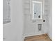 Clean, efficient laundry room with built-in shelving and wood-look plank flooring at 313 W Murray Ave, Durham, NC 27704