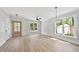 Bright living room showcasing hardwood floors, modern lighting, and large windows offering abundant natural light at 313 W Murray Ave, Durham, NC 27704