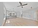 Open-concept living room featuring hardwood floors, recessed lighting, ceiling fan, and a large kitchen island at 313 W Murray Ave, Durham, NC 27704