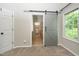 Bathroom featuring a sliding barn door, shower and walk-in closet with custom shelving at 316 Academia Ct, Durham, NC 27713