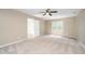 Spacious carpeted bedroom features a ceiling fan and a window for natural light at 316 Academia Ct, Durham, NC 27713