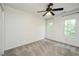 Bright bedroom features neutral walls, two windows for natural light, and a ceiling fan at 316 Academia Ct, Durham, NC 27713