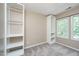 Neutral bedroom with built-in shelving, carpeting, and natural light from the double window at 316 Academia Ct, Durham, NC 27713