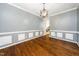 Formal dining room with hardwood floors and stylish wainscoting at 316 Academia Ct, Durham, NC 27713