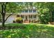 Charming two-story home featuring a large front porch and lush landscaping in a wooded community at 316 Academia Ct, Durham, NC 27713