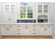 Bright kitchen with lots of windows, white cabinets, and luxury countertops at 316 Academia Ct, Durham, NC 27713