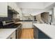 Open kitchen featuring white cabinets, stainless steel appliances, and a beautiful blue backsplash at 316 Academia Ct, Durham, NC 27713