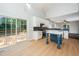 Open-concept kitchen with island, modern appliances, and access to deck at 316 Academia Ct, Durham, NC 27713