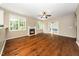 View of the living room showcasing hardwood floors, a fireplace, and ample natural light at 316 Academia Ct, Durham, NC 27713