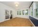 Bright sunroom features tiled floors, large windows, and French doors at 316 Academia Ct, Durham, NC 27713