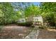 Spacious backyard with stone walkway and lush greenery, providing a serene outdoor escape at 3306 Meadowrun Dr, Durham, NC 27707