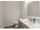 Cozy half bathroom featuring wood-look floors, a white sink, and a framed mirror at 3306 Meadowrun Dr, Durham, NC 27707