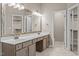 Bathroom with dual sinks, vanity, and a walk-in closet at 3306 Meadowrun Dr, Durham, NC 27707
