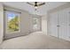 Bright bedroom with carpeting, ceiling fan and double closet doors at 3306 Meadowrun Dr, Durham, NC 27707