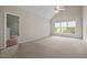 Spacious carpeted bedroom with vaulted ceiling and large picture window views at 3306 Meadowrun Dr, Durham, NC 27707