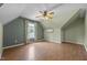 Bedroom with hardwood floors and a ceiling fan, featuring large window views at 3306 Meadowrun Dr, Durham, NC 27707
