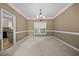 Bright dining room with a chandelier, neutral walls, and large window at 3306 Meadowrun Dr, Durham, NC 27707