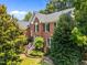 Stunning brick home featuring a well-manicured lawn and classic architectural details at 3306 Meadowrun Dr, Durham, NC 27707