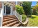 Brick home's entrance features a black front door and well-maintained landscaping for a welcoming approach at 3306 Meadowrun Dr, Durham, NC 27707