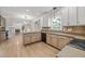 Kitchen features stone countertops, hardwood floors, and an open floor plan at 3306 Meadowrun Dr, Durham, NC 27707