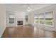 Inviting living room with hardwood floors, fireplace, and multiple windows for natural light at 3306 Meadowrun Dr, Durham, NC 27707