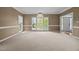 Spacious living room filled with natural light from large windows, carpeted for comfort at 3306 Meadowrun Dr, Durham, NC 27707