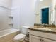 White bathroom featuring a shower-tub combination, white tiling, and a granite sink countertop at 354 Crimson Way, Pittsboro, NC 27312