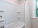 A bathtub shower combination with white surround and curtain at 354 Crimson Way, Pittsboro, NC 27312