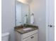 The half bathroom vanity features granite countertop, undermount sink, and framed mirror at 354 Crimson Way, Pittsboro, NC 27312