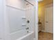 A bathtub shower combination with white surround and curtain rod at 354 Crimson Way, Pittsboro, NC 27312
